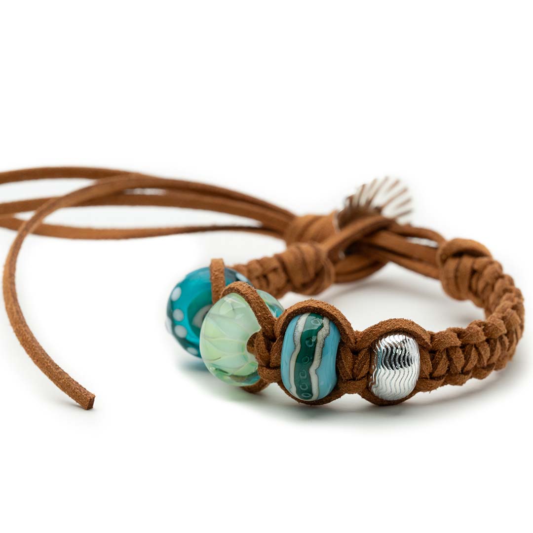 Brown cord bracelet with green and silver glass surf beads.