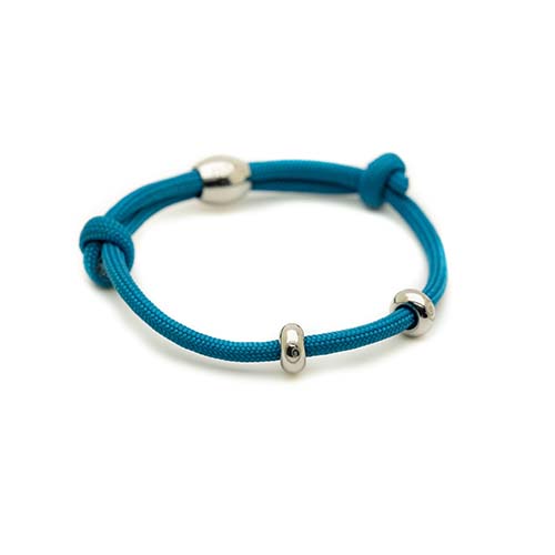 Blue bracelet with silver beads on a white background