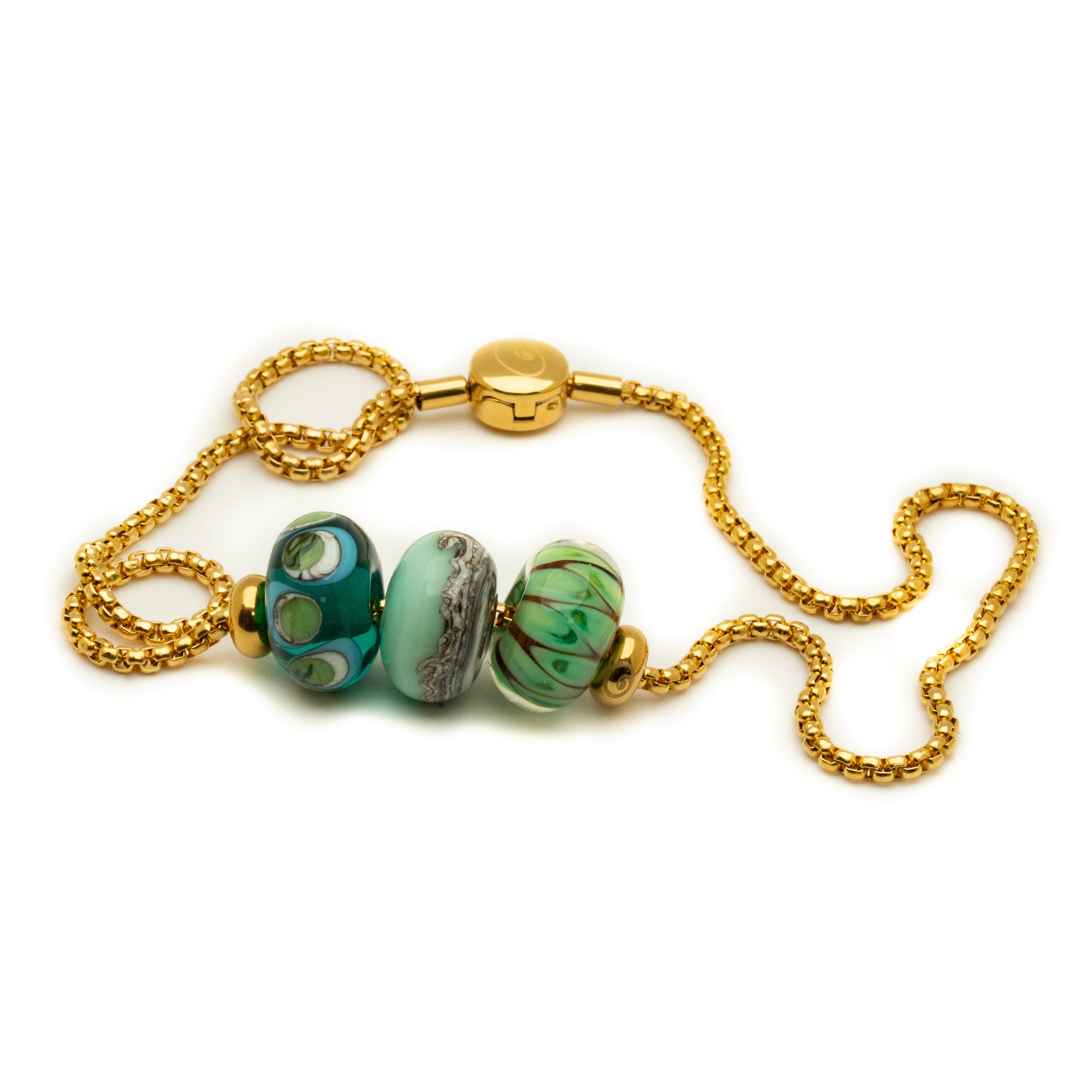 Bracelet with gold chain and green beads on a white background