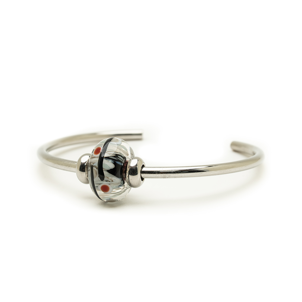 Glass bead on steel bangle on a white background