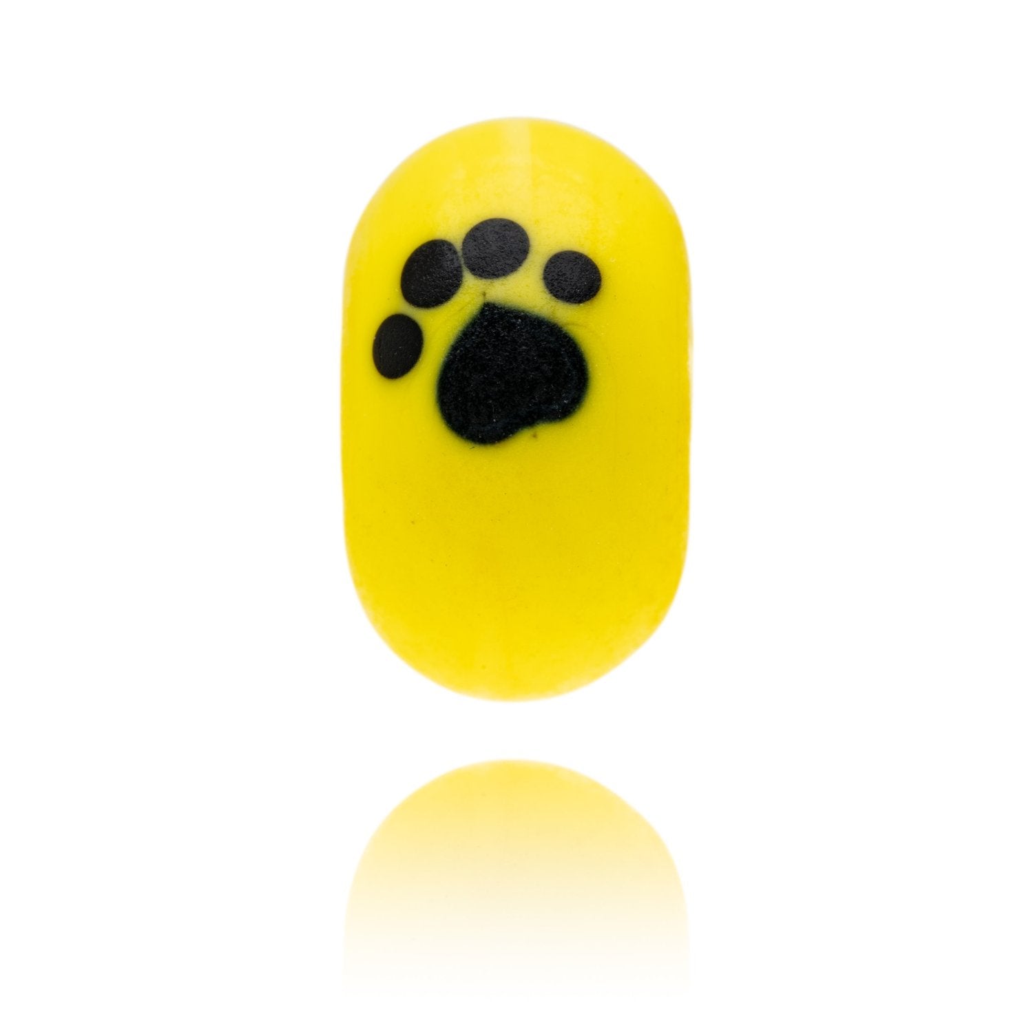 Bright yellow glass bead with a black paw print, being sold to support the Dogs Trust.