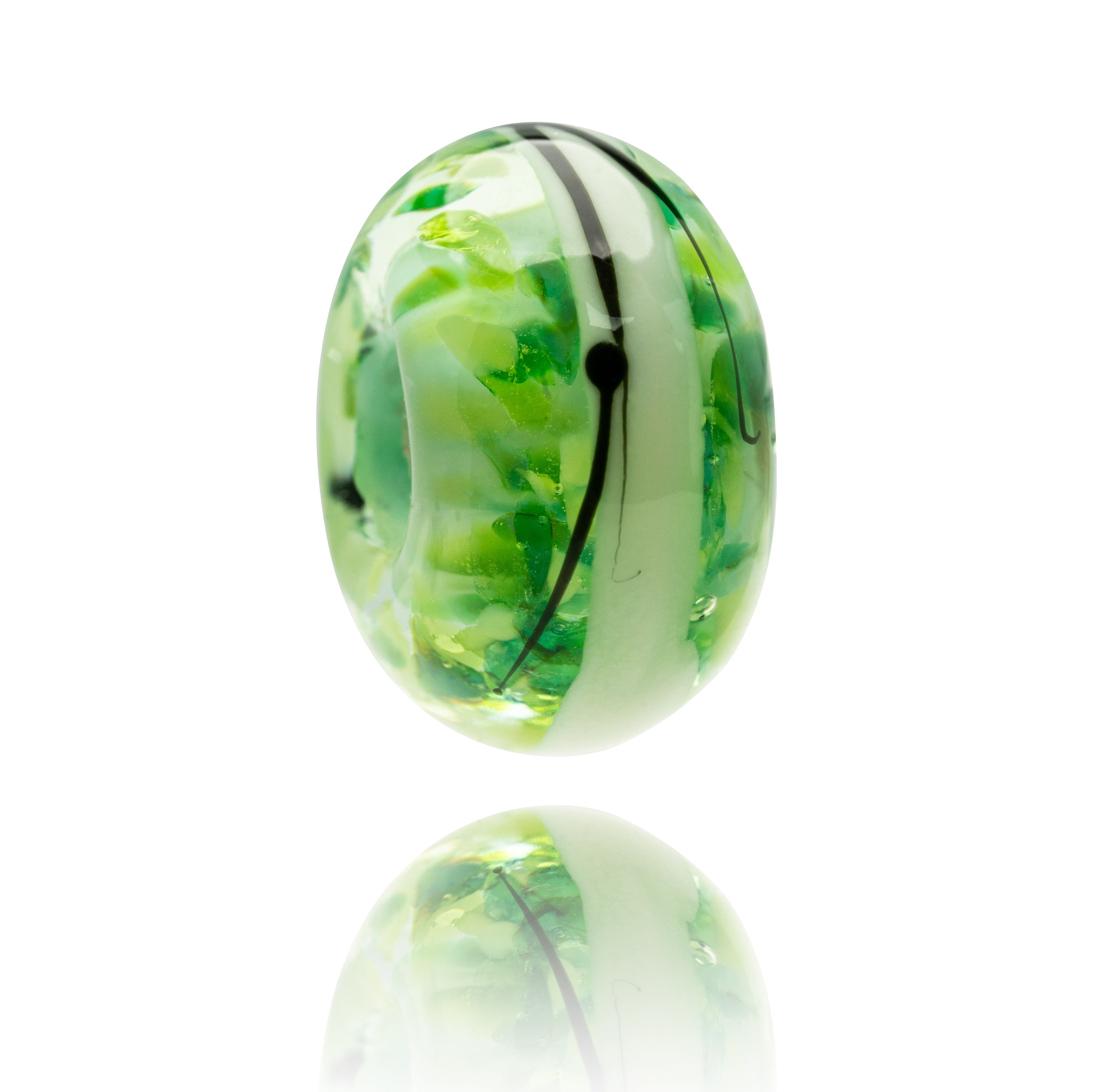 Green and white marbled glass bead on a white background