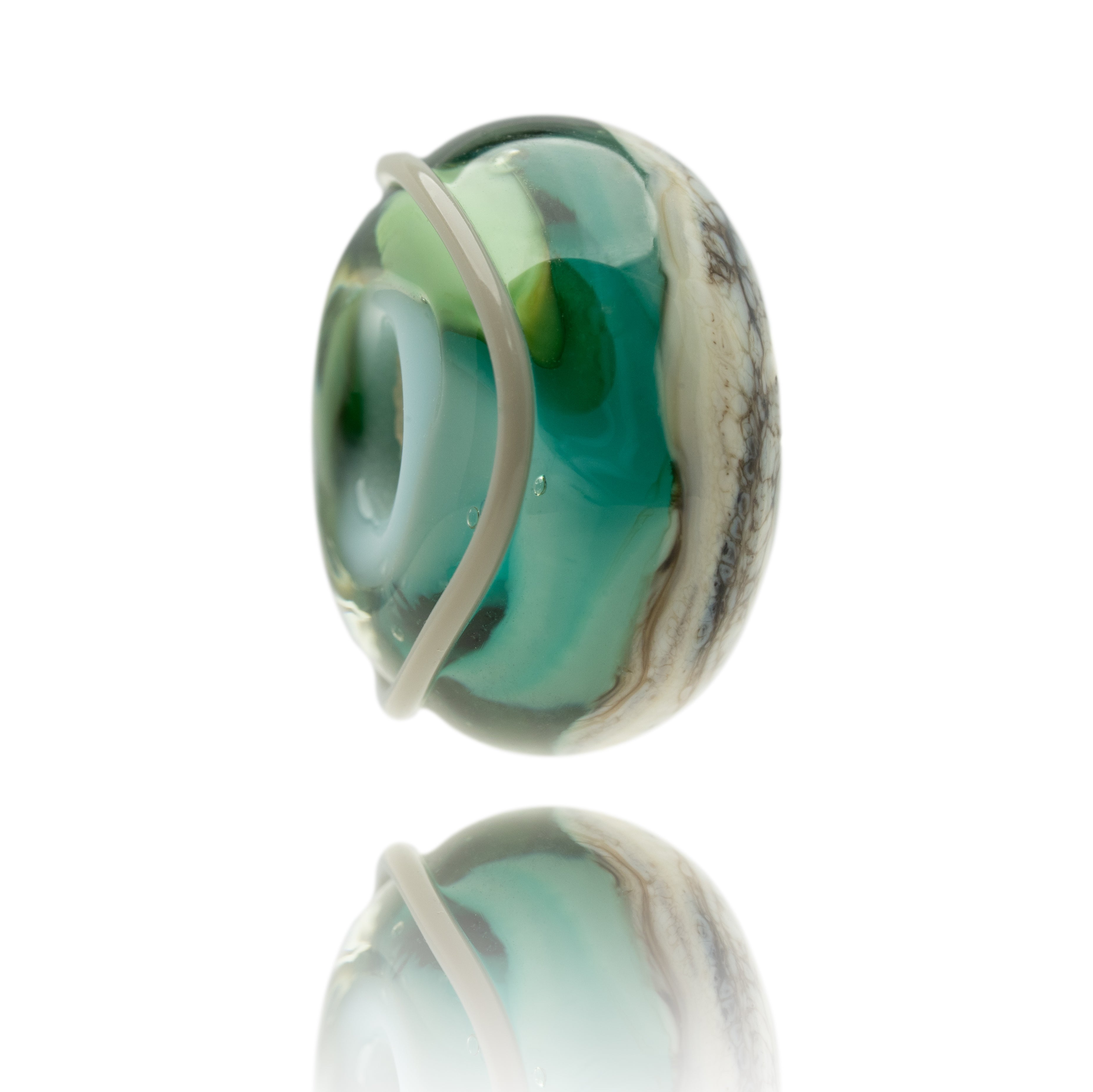 Green and blue swirling glass bead with melted grey patterns on surface.