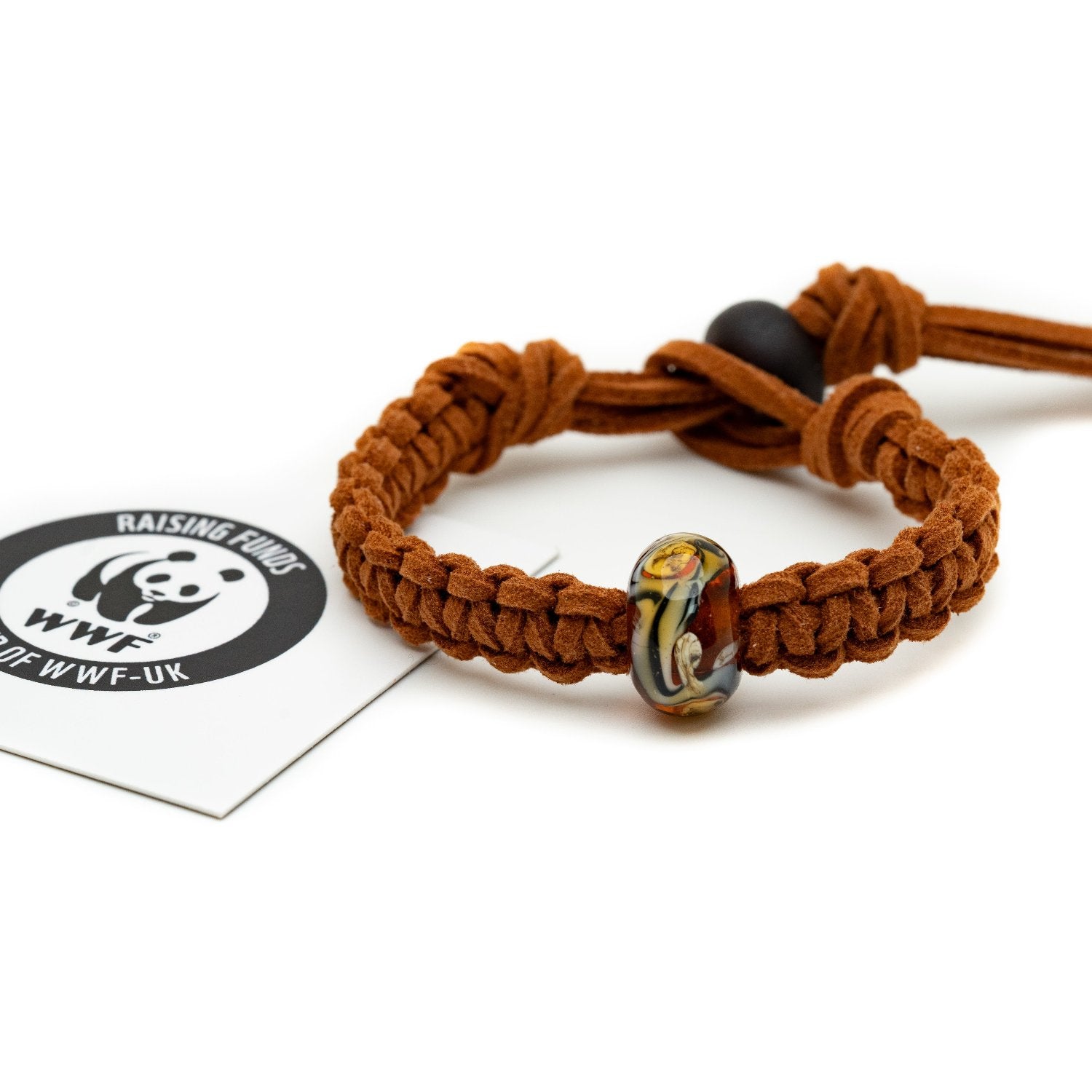 A brown, black and white striped bead bracelet representing a Tiger being sold to raise funds for the World Wildlife Foundation.