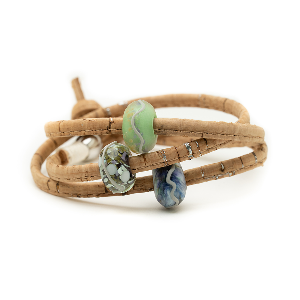 Brown cork wrap bracelet with three colourful beads on a white background