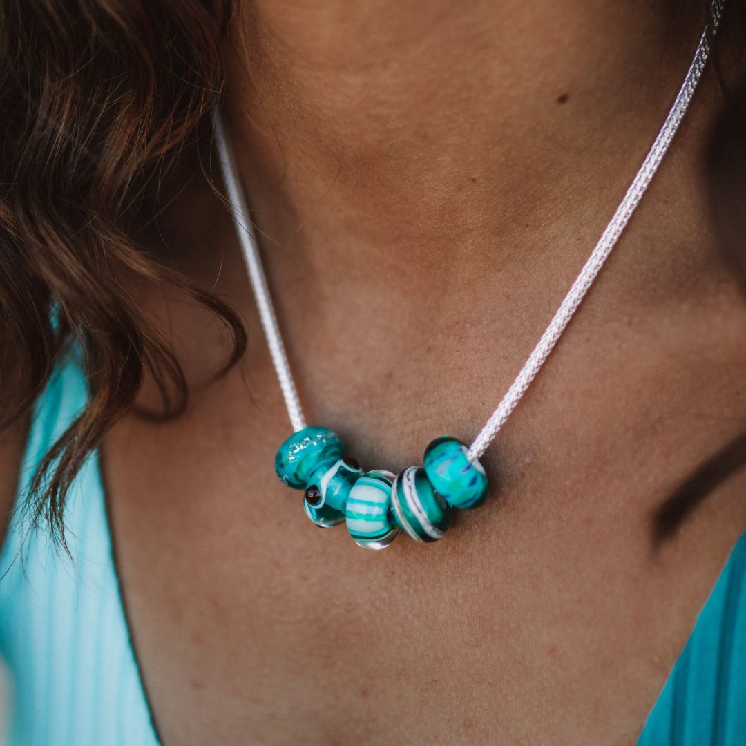 Turquoise glass beach inspired beads worn on sterling silver chunky necklace.