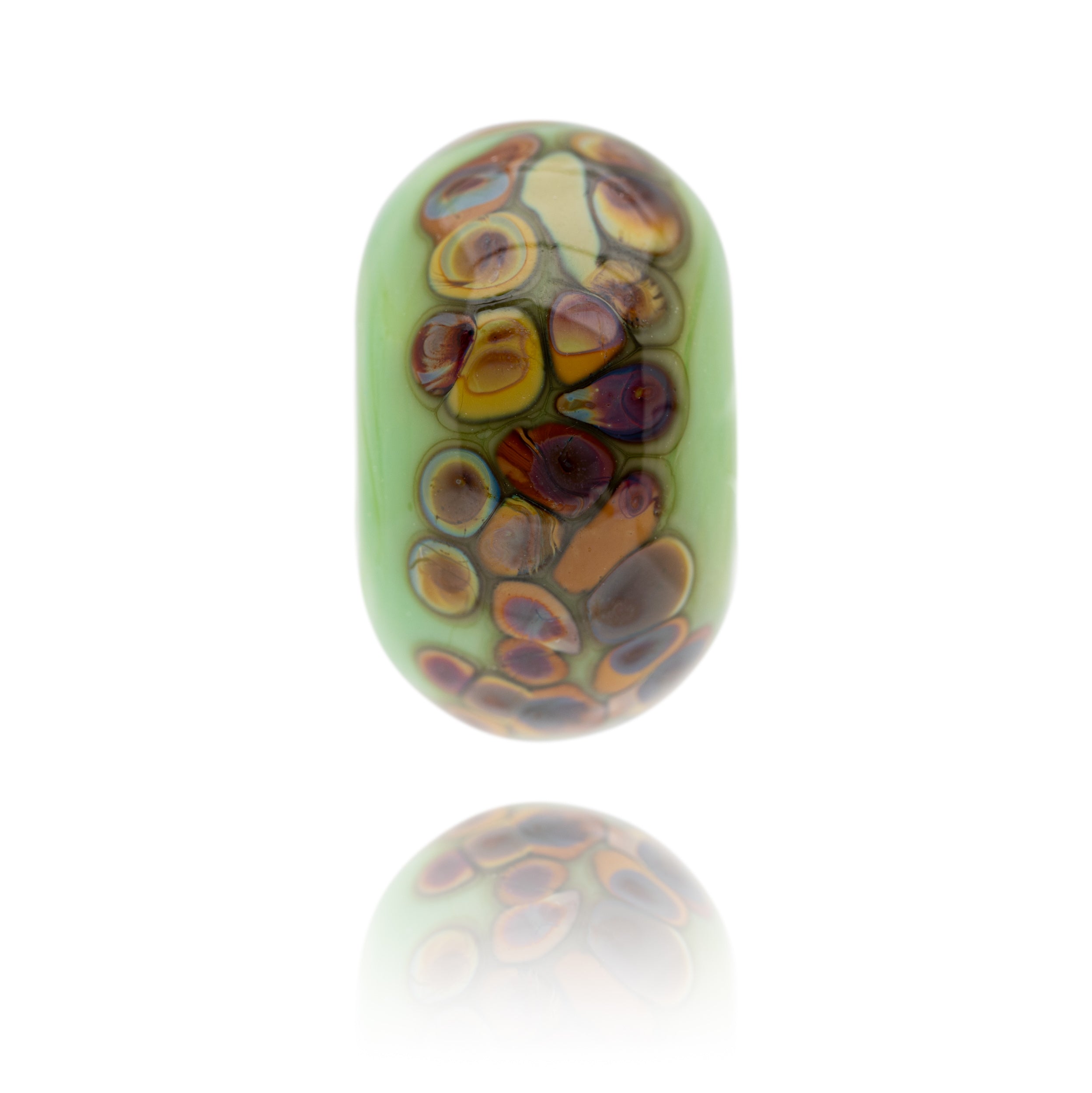 A green glass bead with brown spots on the surface being sold to raise funds for the World Wildlife Foundation.