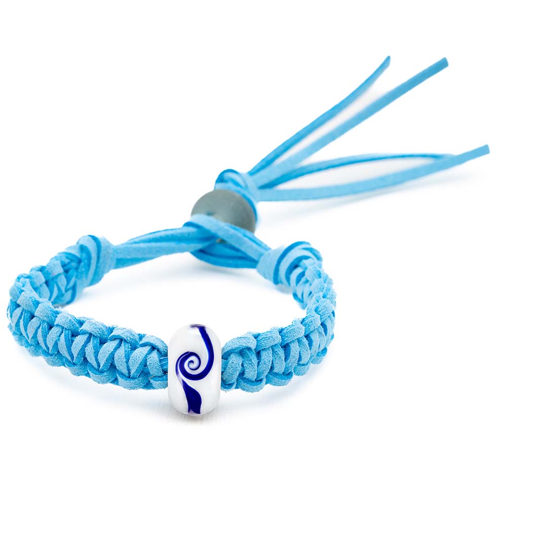 White glass bead bracelet with a dark blue swirl pattern, sold in support of the Wave Project.