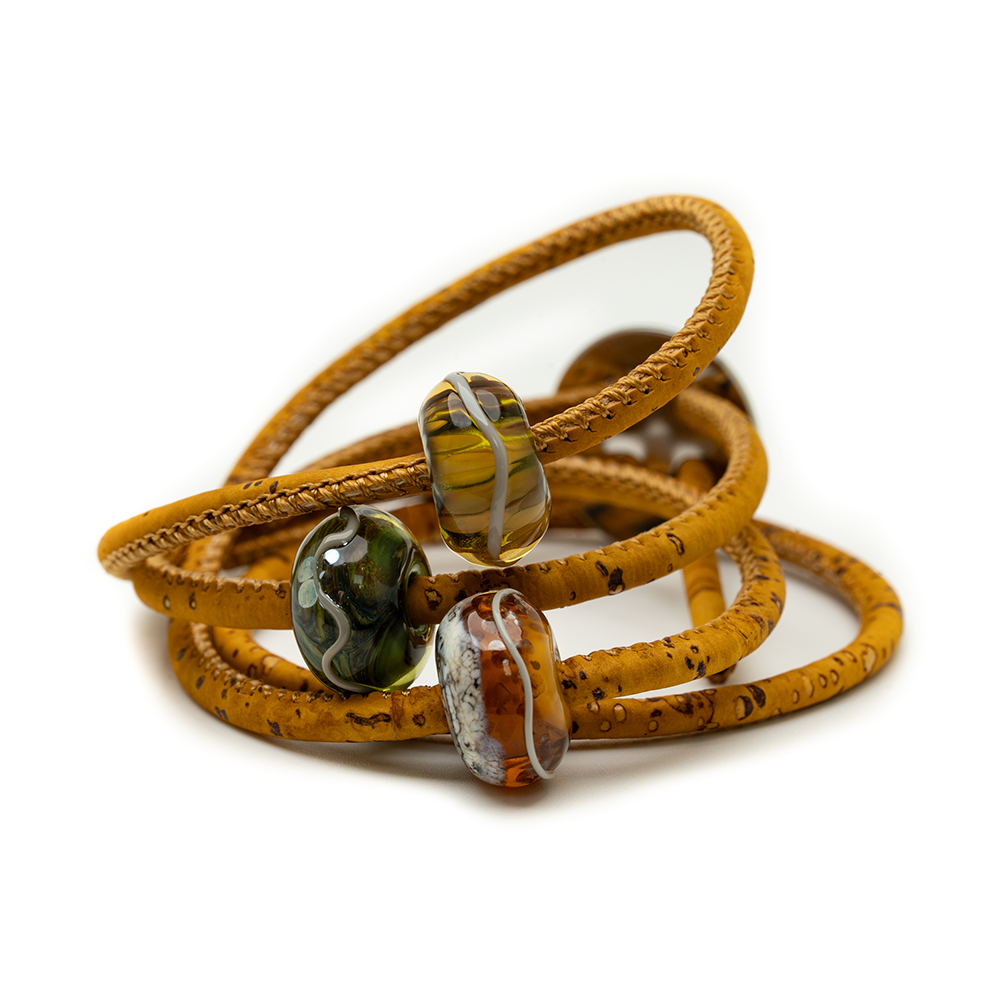 Yellow cork bracelet with glass beads on a white background