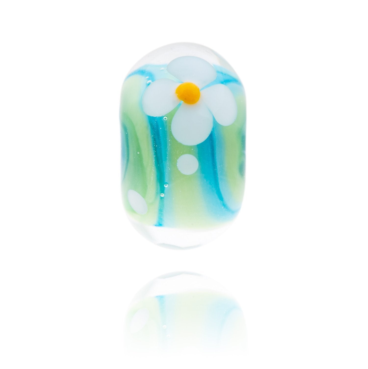 Blue and green swirly glass bead with a white flower decoration on the surface, representing Woolacombe beach in North Devon.