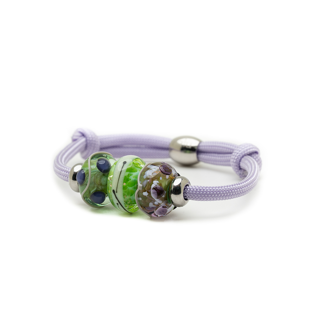 Bracelet with green bead and silver accents on a white background