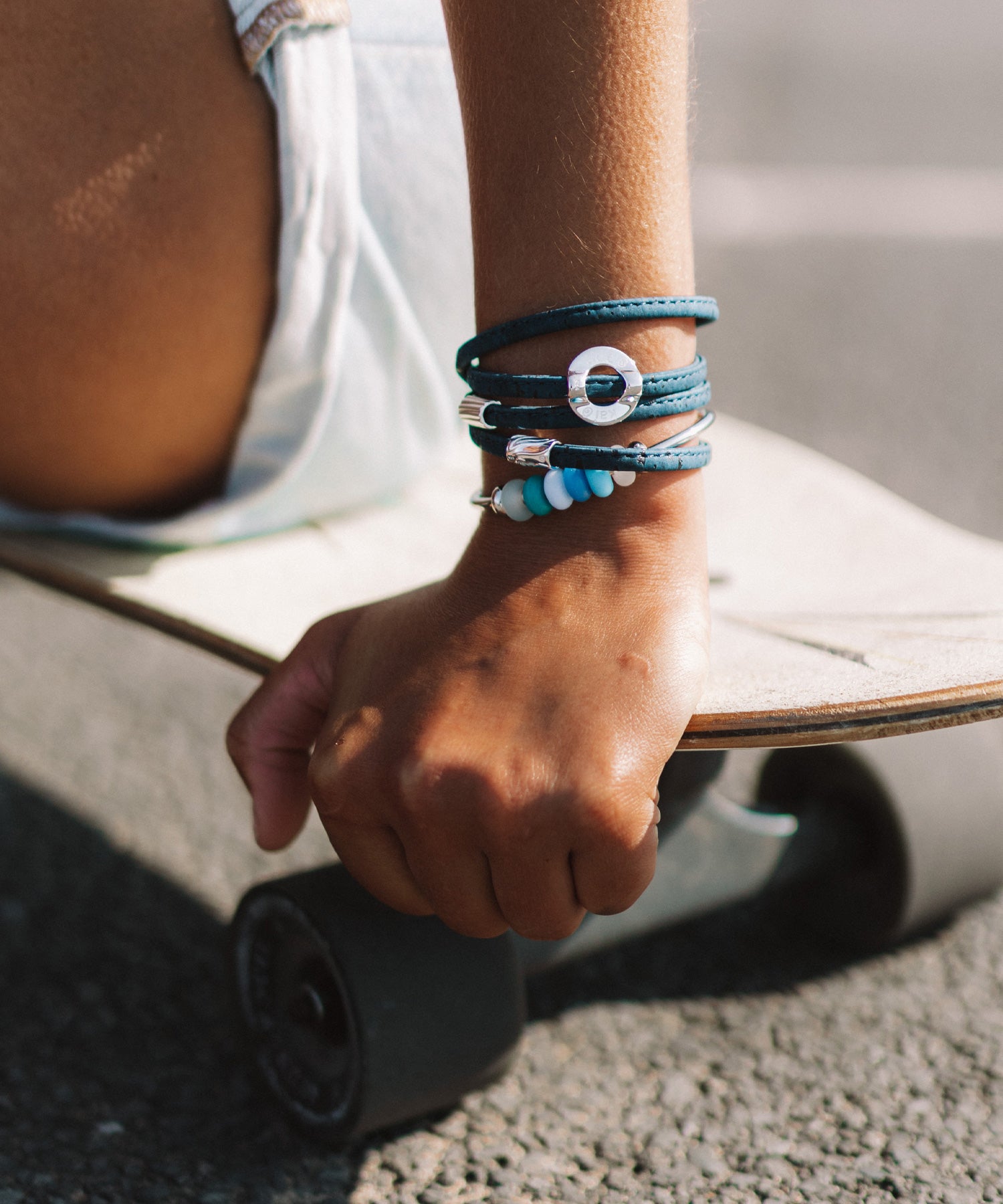 Silver beads on navy cork wrap worn by skater girl.