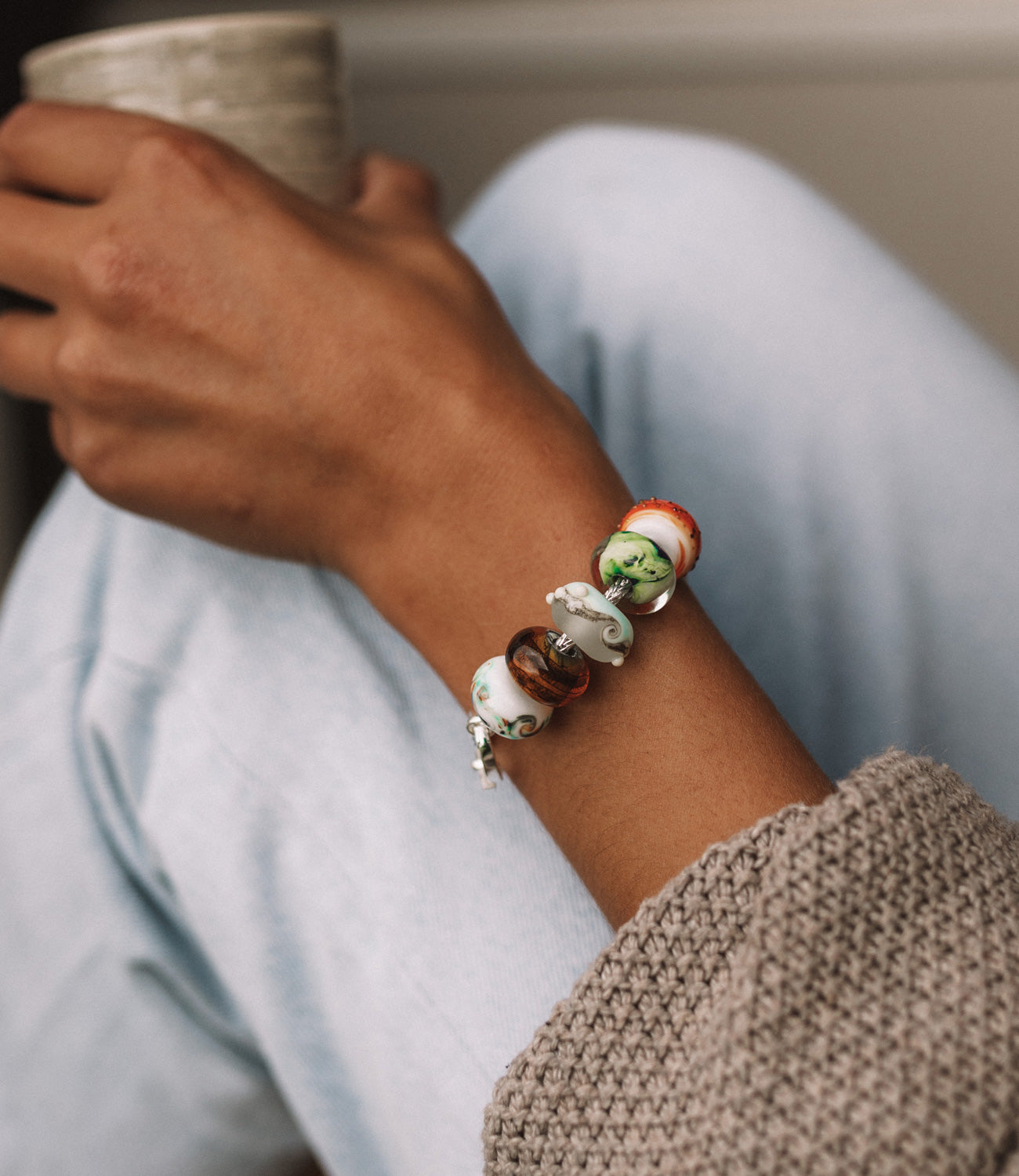 Dorset beach inspired glass beads in autumn colours worn on silver bracelet.