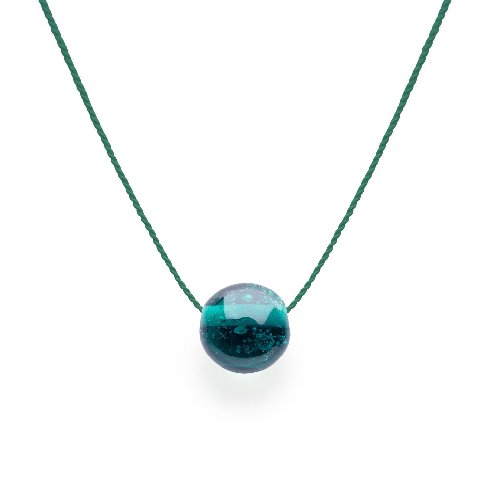 Teal necklace with a round pendant on a white background