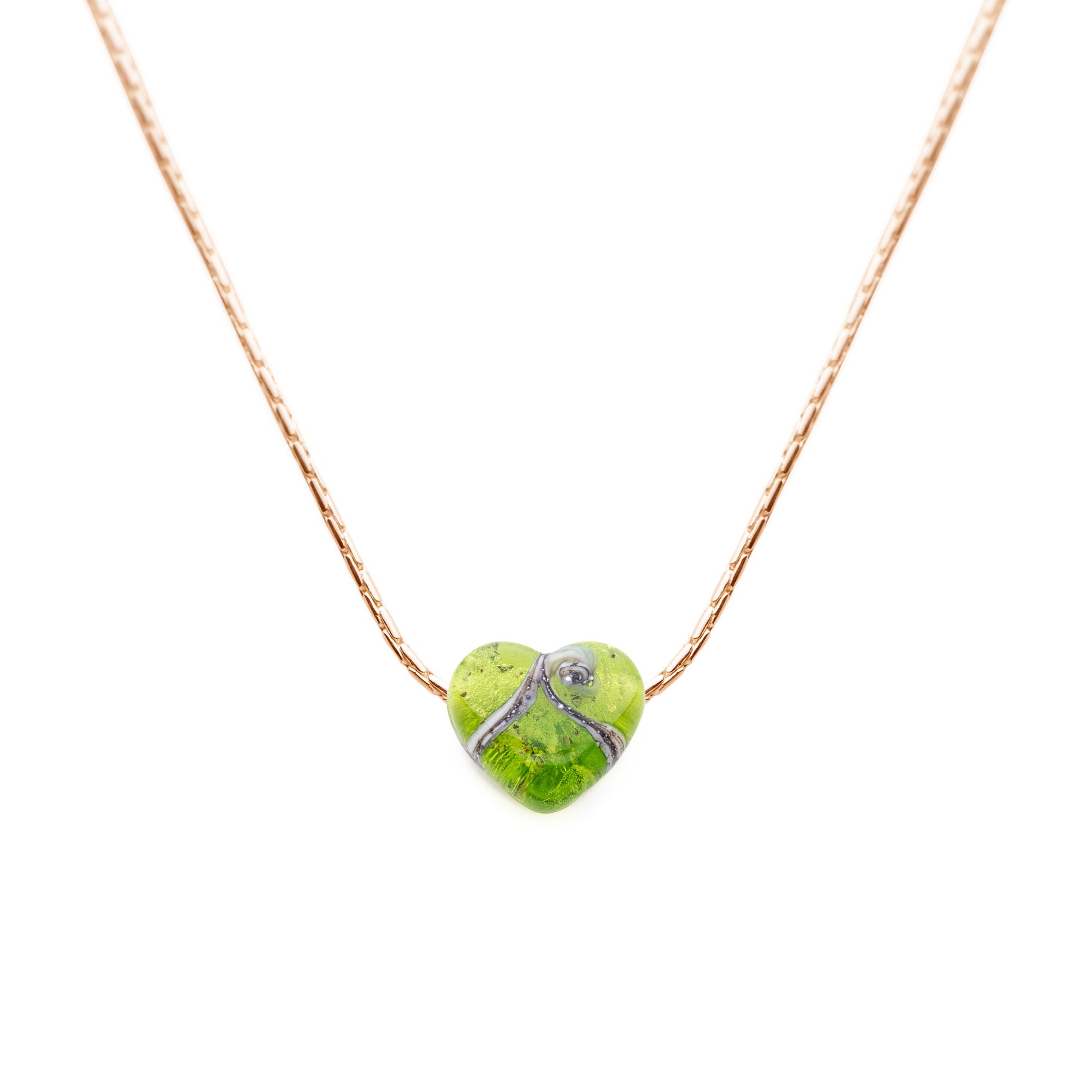 Apple green coloured glass heart shaped bead with grains of sand from your chosen beach in the glass, strung on a gold necklace.