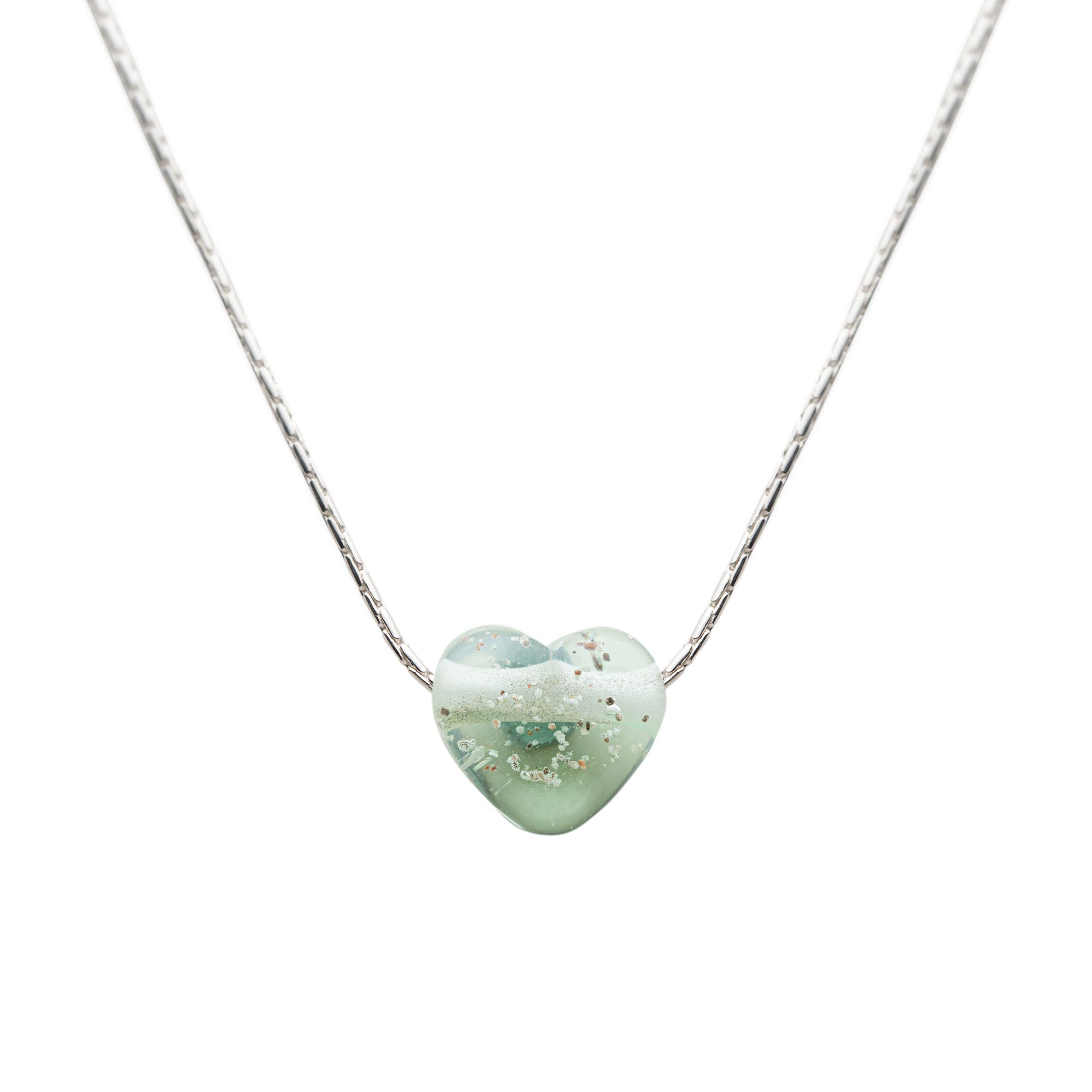 Heart-shaped green pendant on a silver chain against a white background