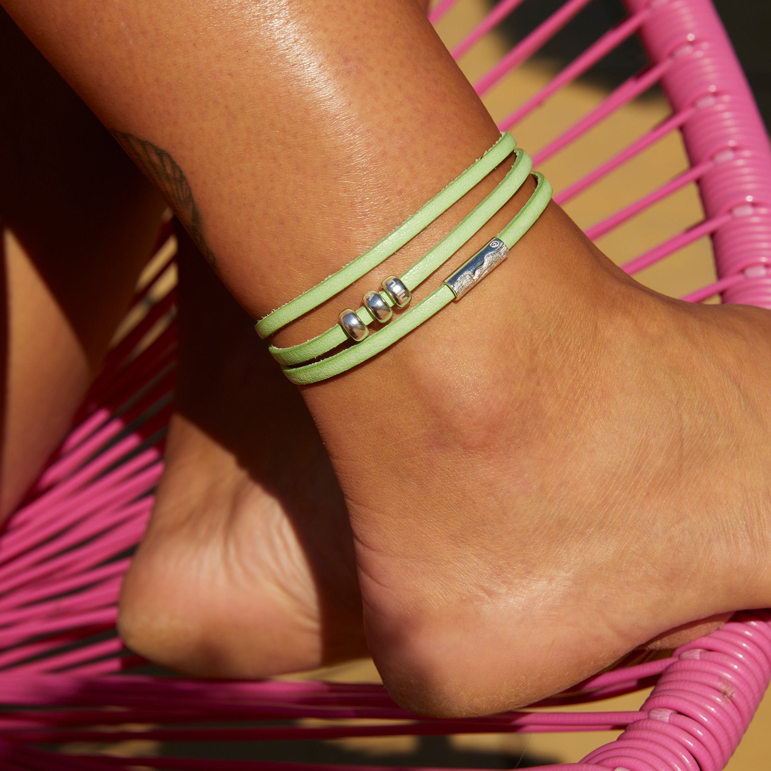 Mint leather wrap anklet with silver charm beads.