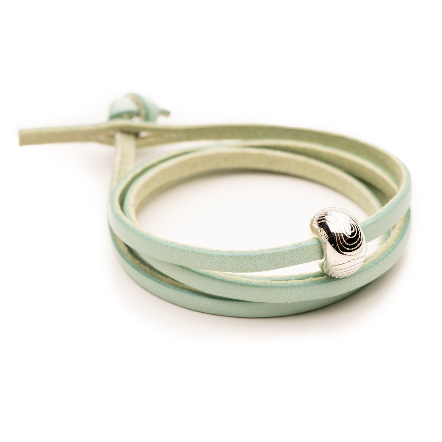 Aqua colour leather wrap with a silver bead worn it.