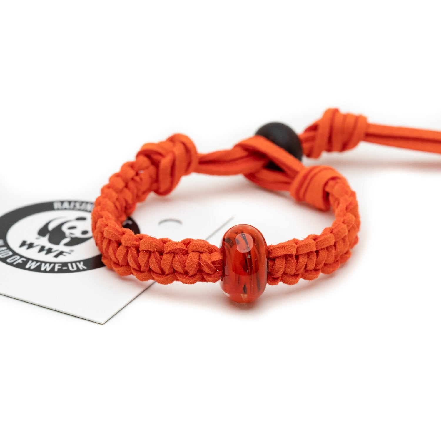 Orange bracelet with red glass bead, sold for the WWF.