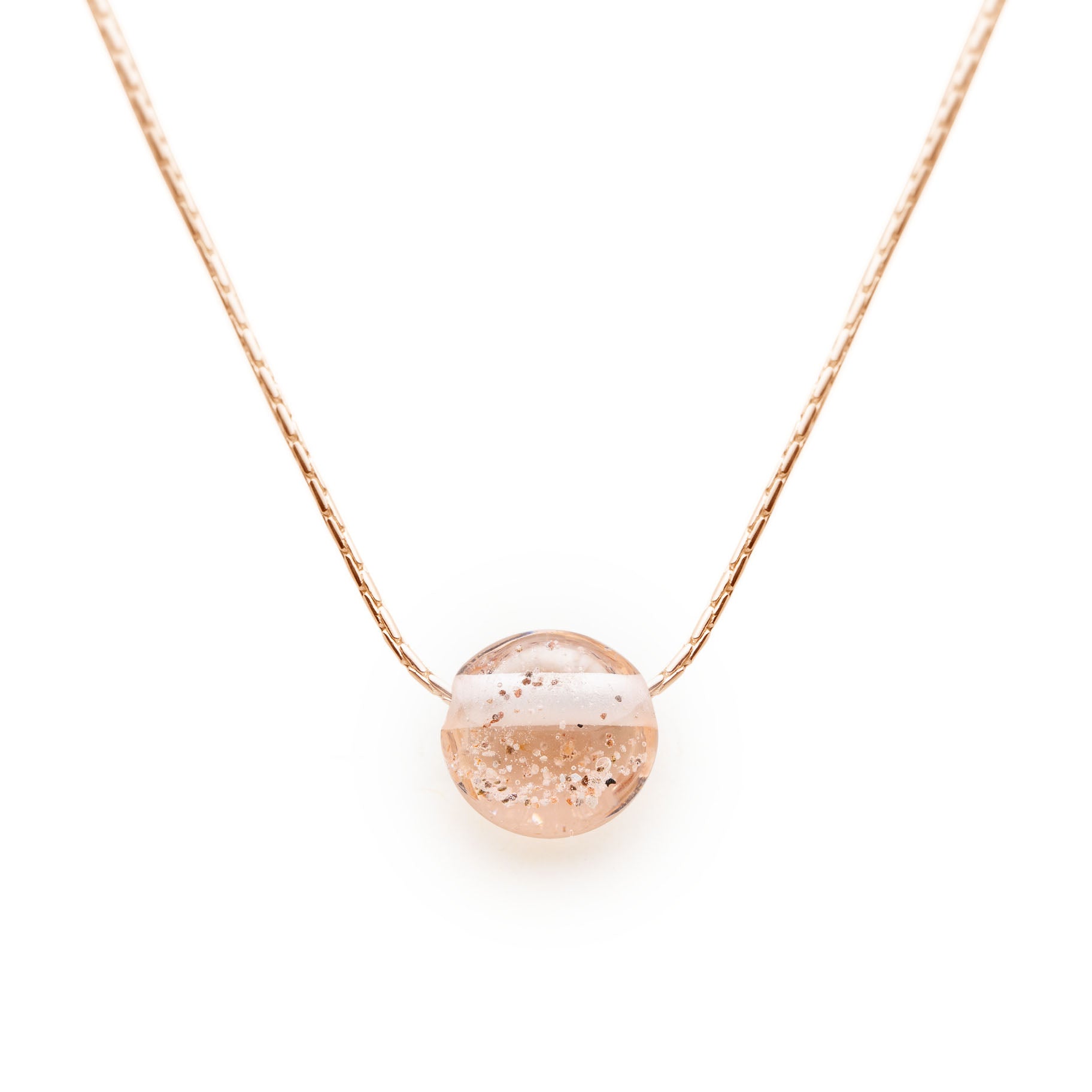 Gold necklace with peach coloured glass pebble with your chosen beach sand melted into the glass.