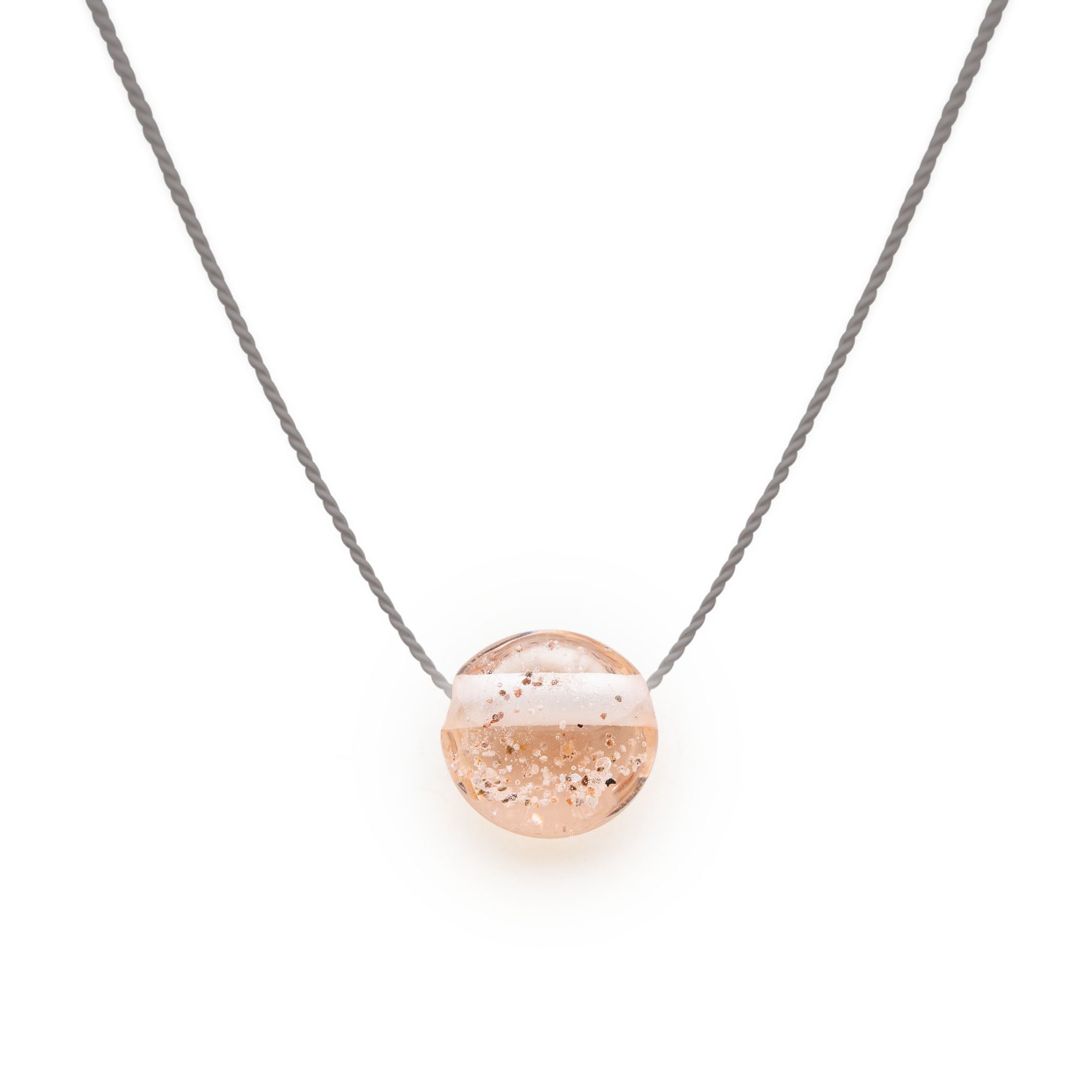 Peach glass sand pebble on silk cord necklace