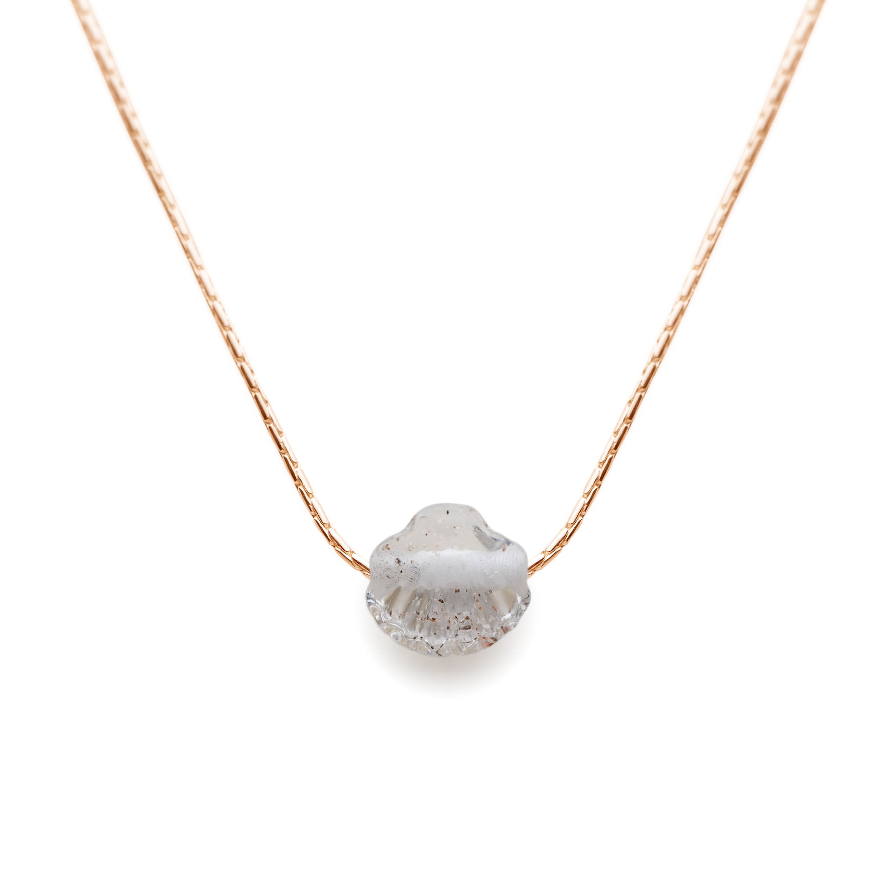 Gold Necklace with a textured pendant on a white background
