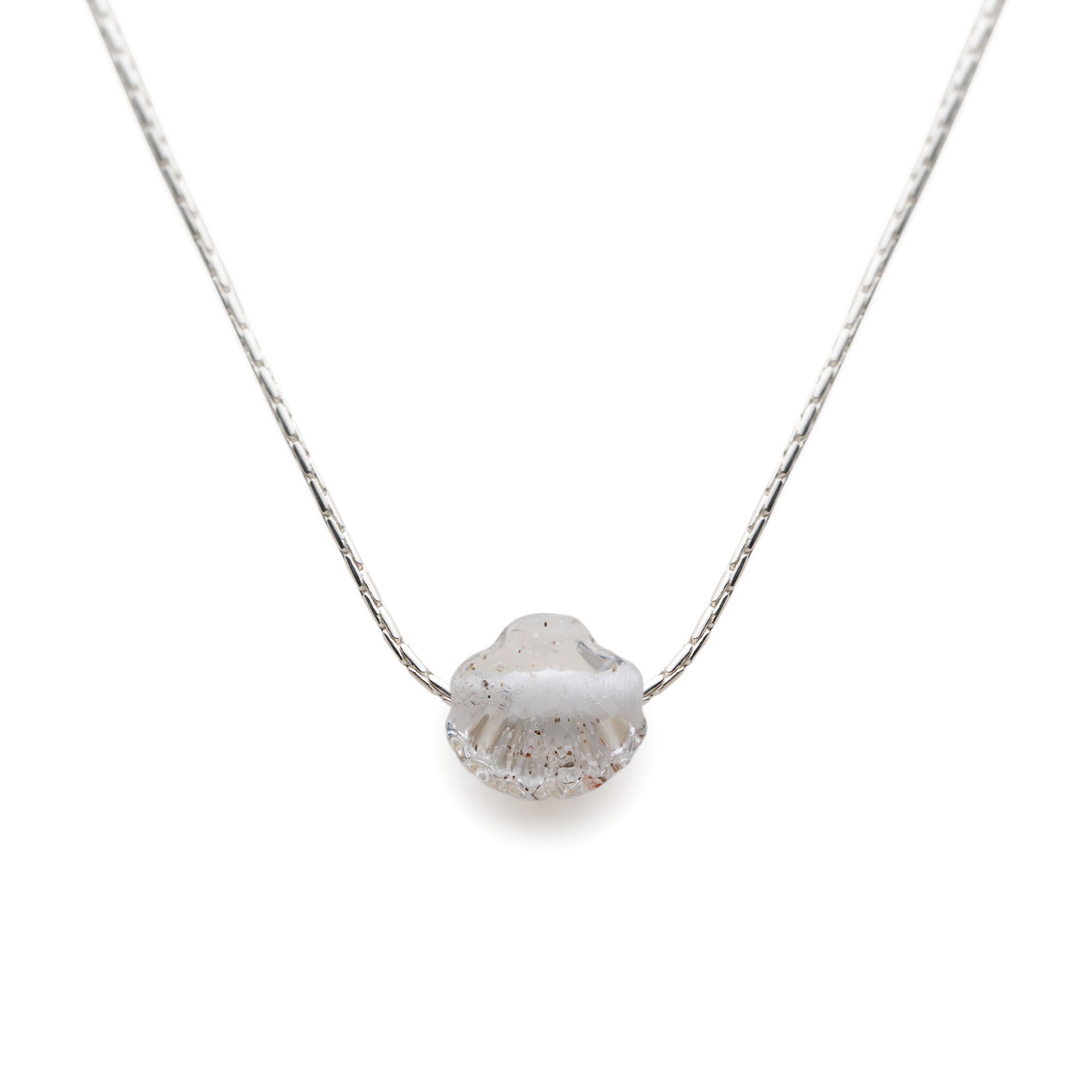 Clear glass bead in the shape of a shell on a silver chain necklace.