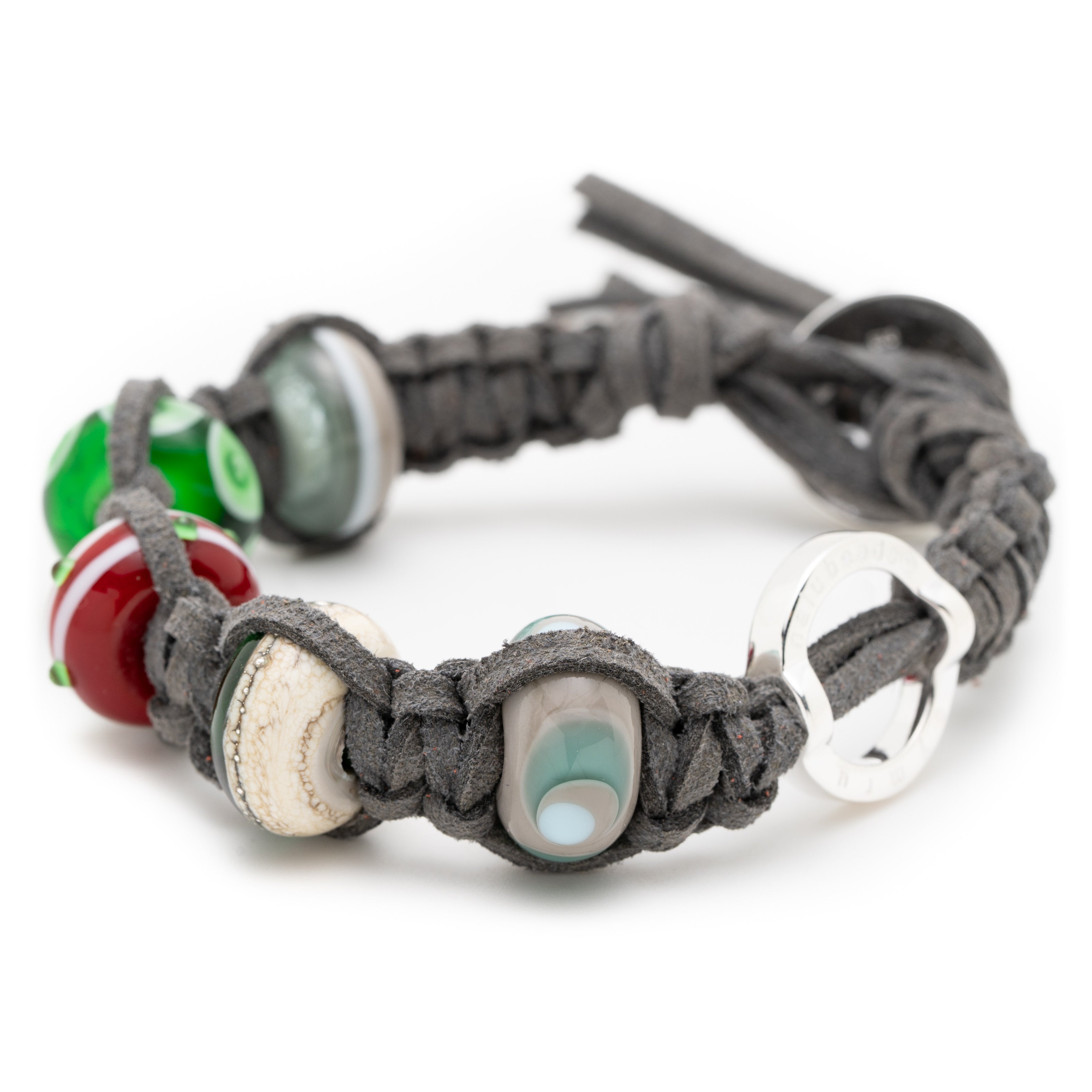 Grey cord anklet with grey, green, red and silver beads attached.