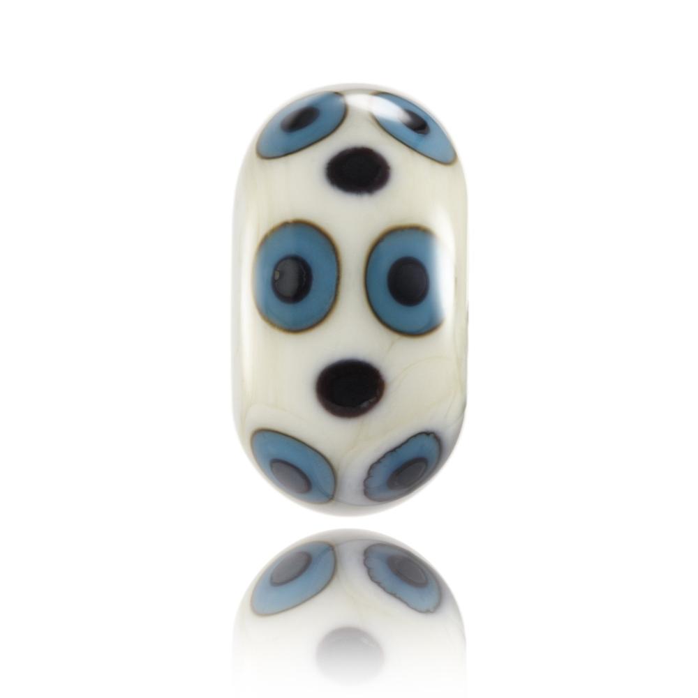 Cream glass bead with purple and blue dots on the surface, design for Lacanau in France.