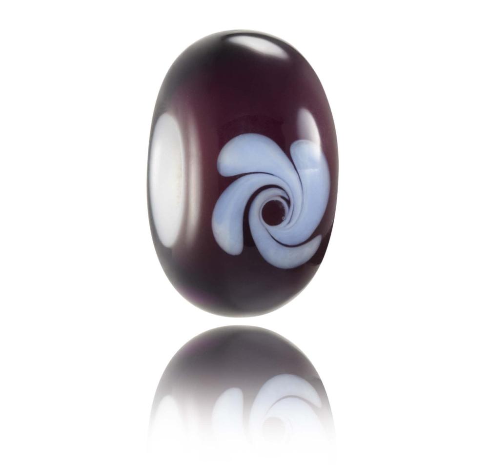 Dark purple glass bead with light purple flower style decoration on the surface. Designed for Lafitenia in France.