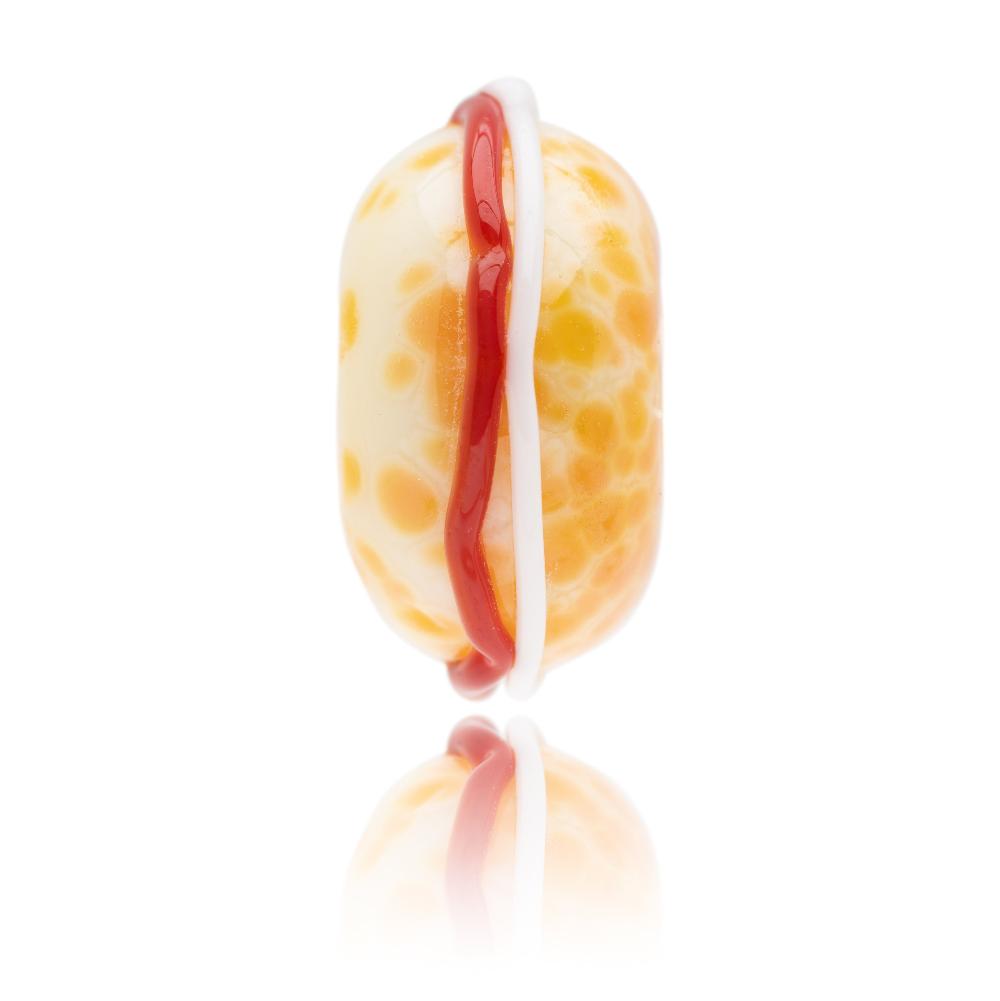 Glass bead representing a cream tea scone with cream and jam.