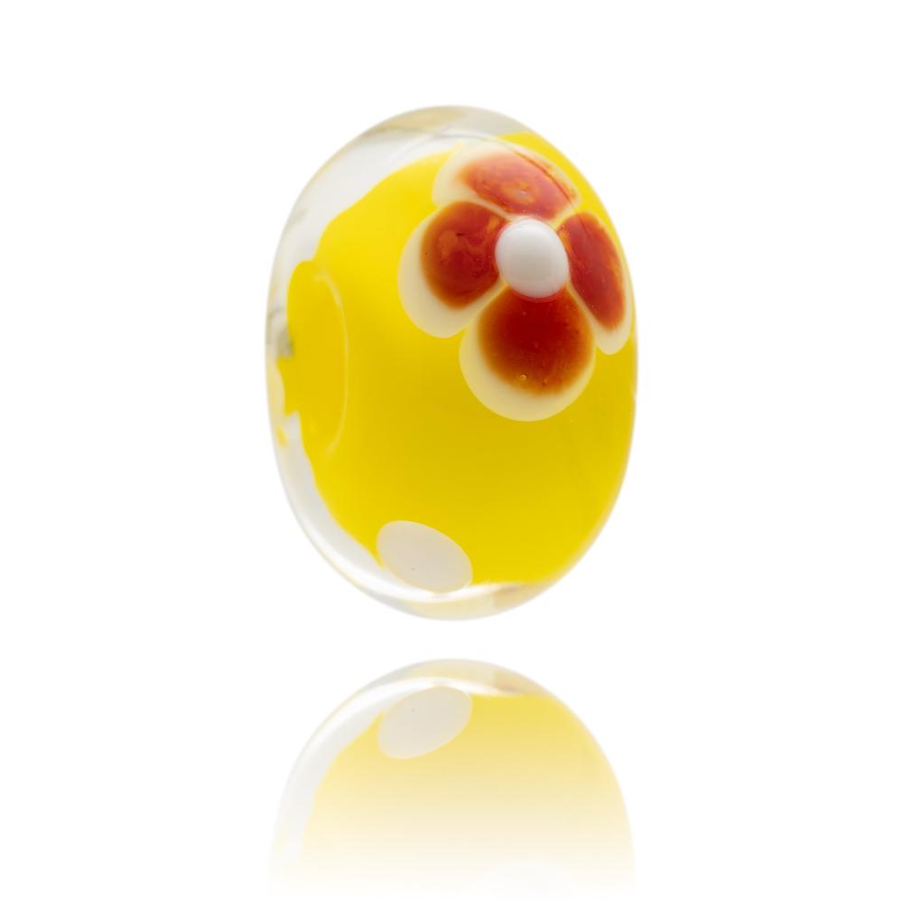 Yellow glass bead with a red flower on the surface, sold to raise funds for the Cystic Fibrosis Trust in the UK.