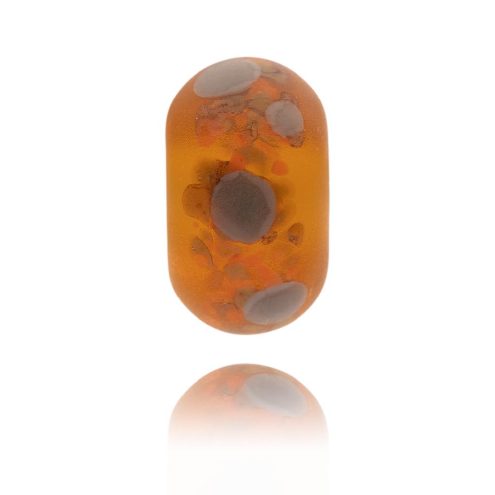 Dark amber transparent glass bead with brown and grey dots on the surface representing Dartmoor National Park.