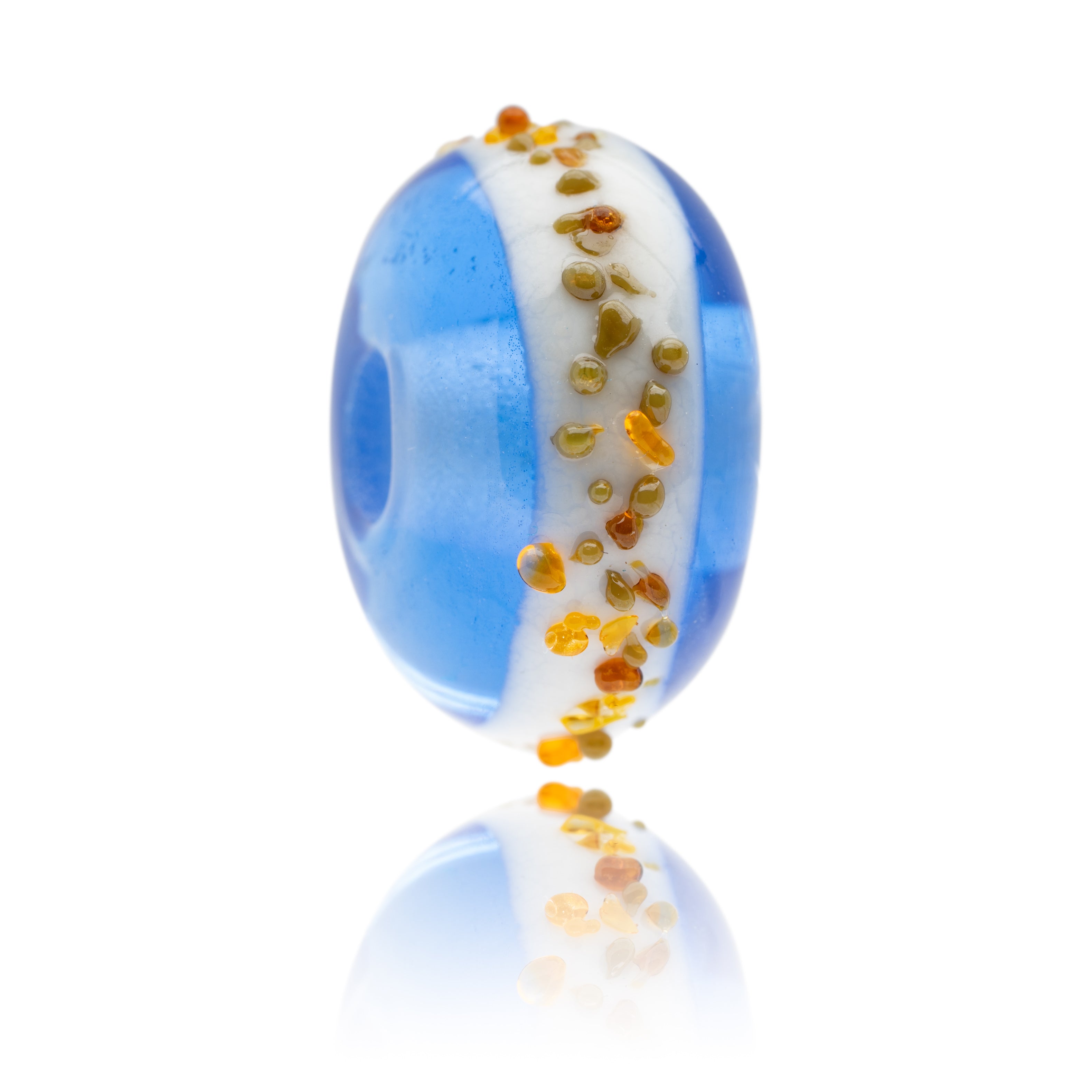 Blue glass surf bead with white stripe and amber glass shard decoration representing Druridge Bay in Northumberland.