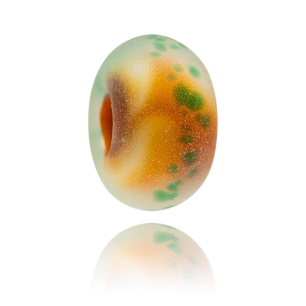 Browny red and white glass bead with frosted surface texture and transparent green dots. Representing Hunstanton Beach in Norfolk.