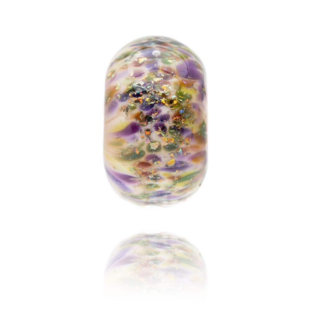 Cream glass bead with sparkle and glitter on the surface in purple, green and gold.