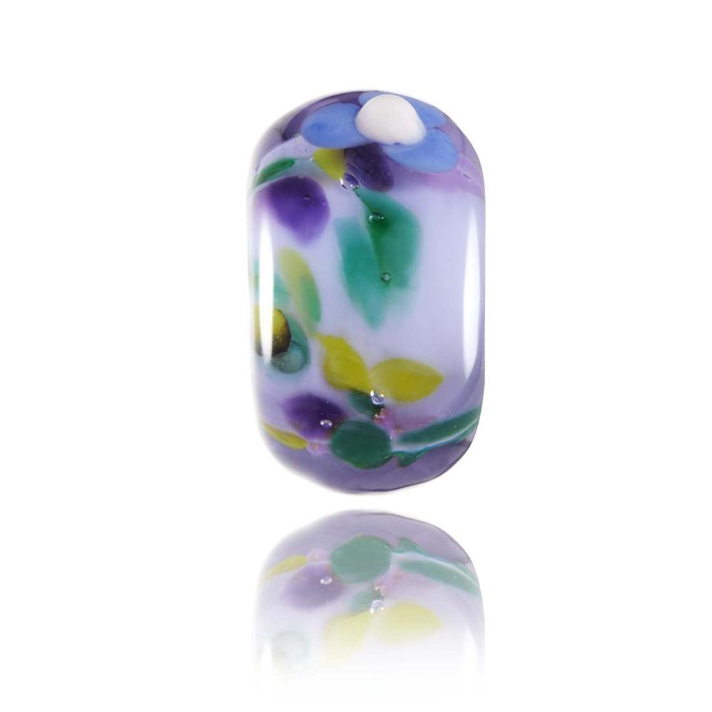 Purple transparent glass bead with a spotty green, purple, pink core and a flower decoration on the surface. Designed for Kauai in Hawaii.