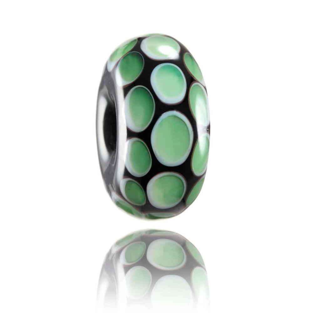 Black glass bead with green dot patterns on the surface, representing Makorori beach in New Zealand.