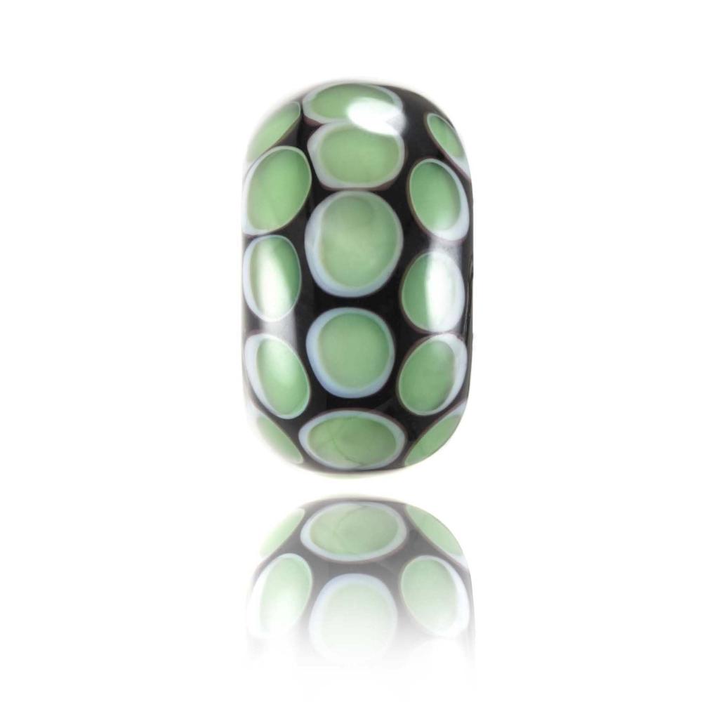 Black glass bead with green dot patterns on the surface, representing Makorori beach in New Zealand.