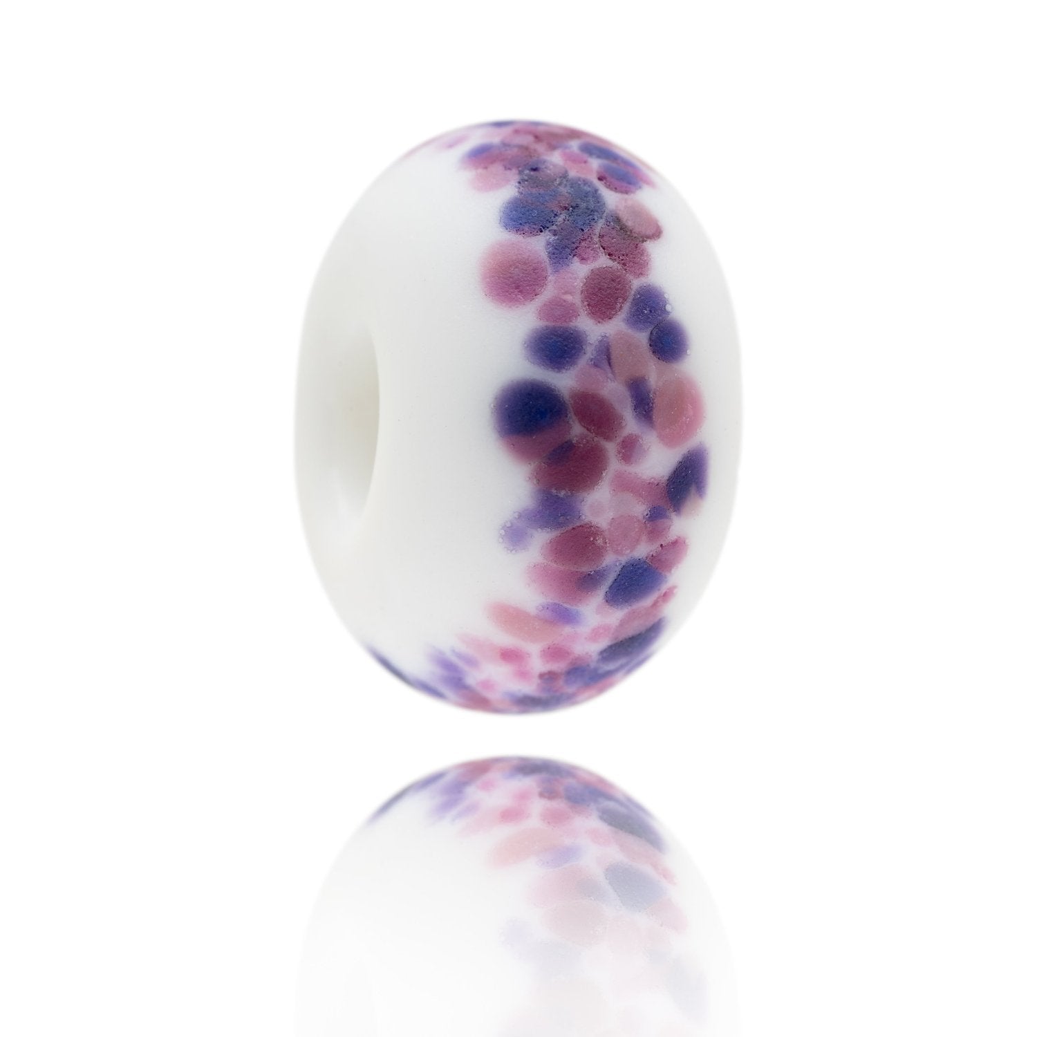 White glass bead with pink and purple spots on the surface representing the Nevis Range in Scotland.