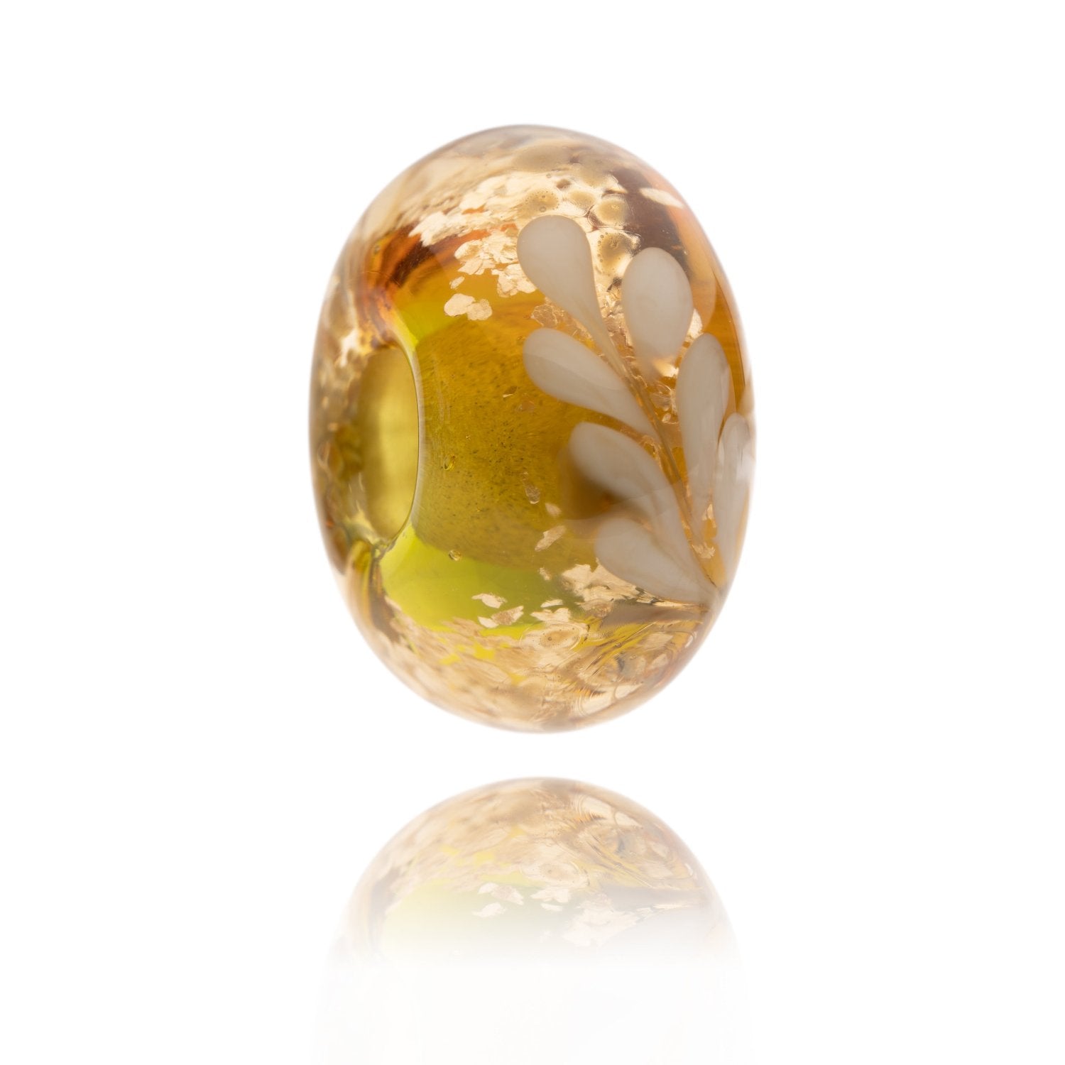 Gold, green and amber shimmering glass bead with a white frond pattern representing the New Forest National Park in the UK.