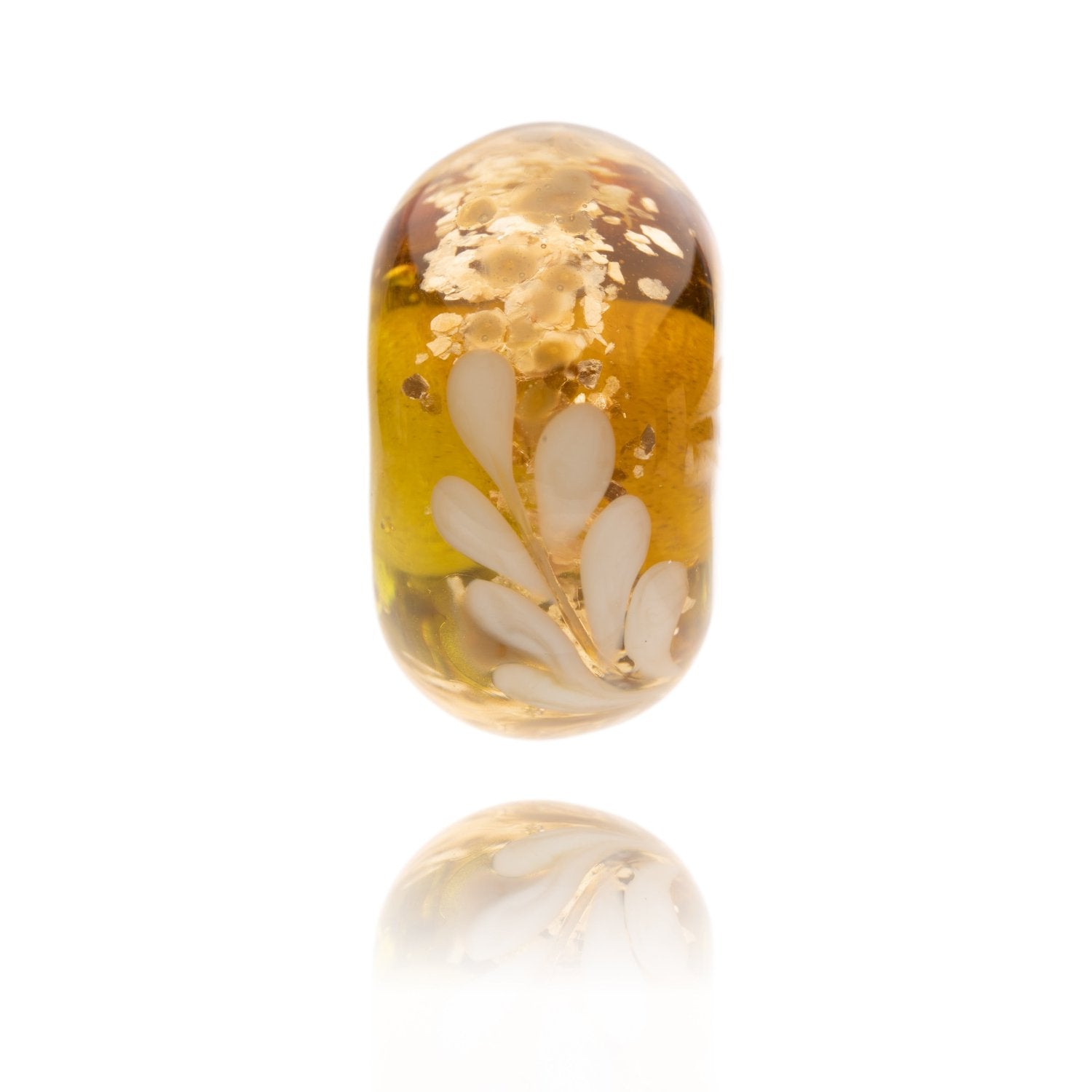 Gold, green and amber shimmering glass bead with a white frond pattern representing the New Forest National Park in the UK.