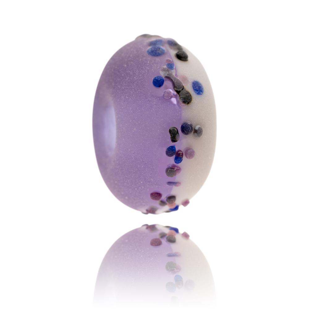 Purple and white glass bead with small blue and purple glass dots on surface for North Uist in Scotland.