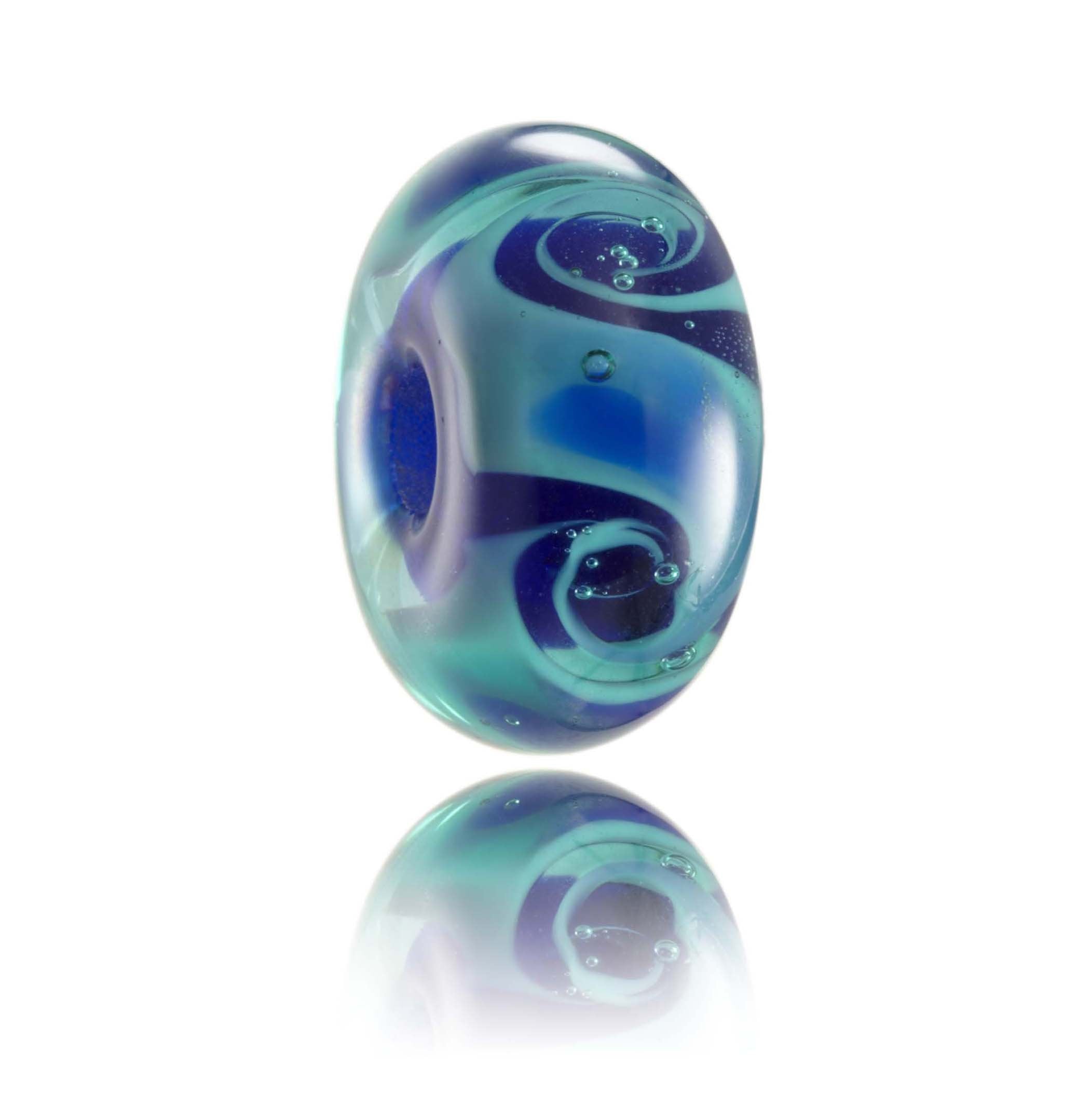Teal and dark blue swirling glass bead inspired by the deep ocean seas of the Atlantic.