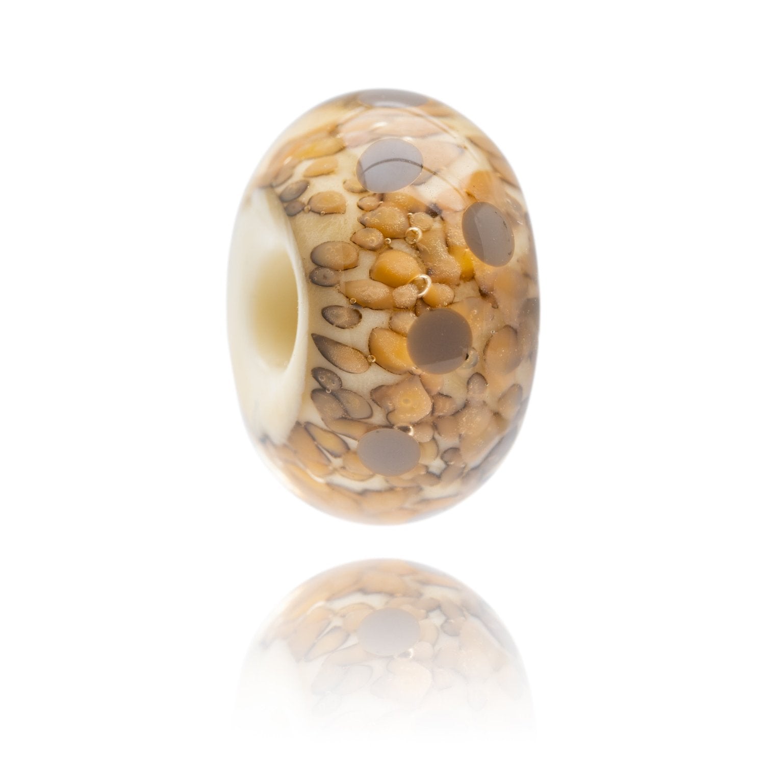 Cream glass bead with brown and grey mottled dots within the glass, representing Ogmore By Sea in South Wales, UK.