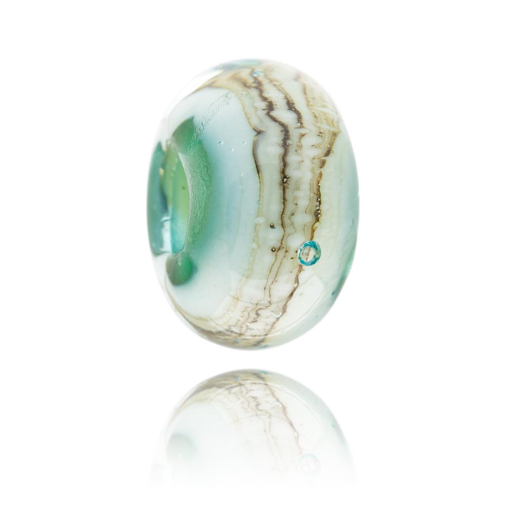 Swirling green, cream and clear glass bead representing Pedn Founder beach in Cornwall.