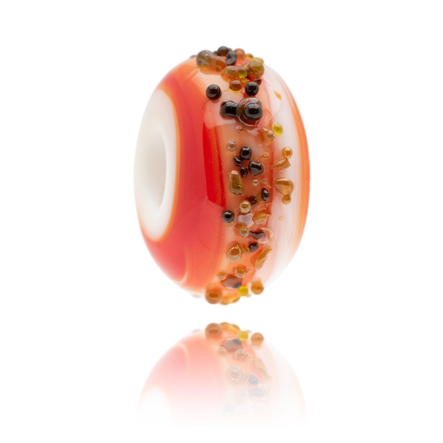 Red, white and orange swirling glass bead with raised specks of glass on the surface. Representing Portland Bill in Dorset, UK.