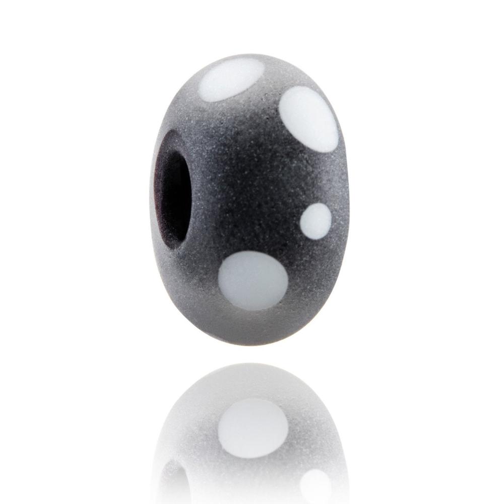 Frosted black glass bead with white dots on the surface representing Mont Tremblant in Canada.