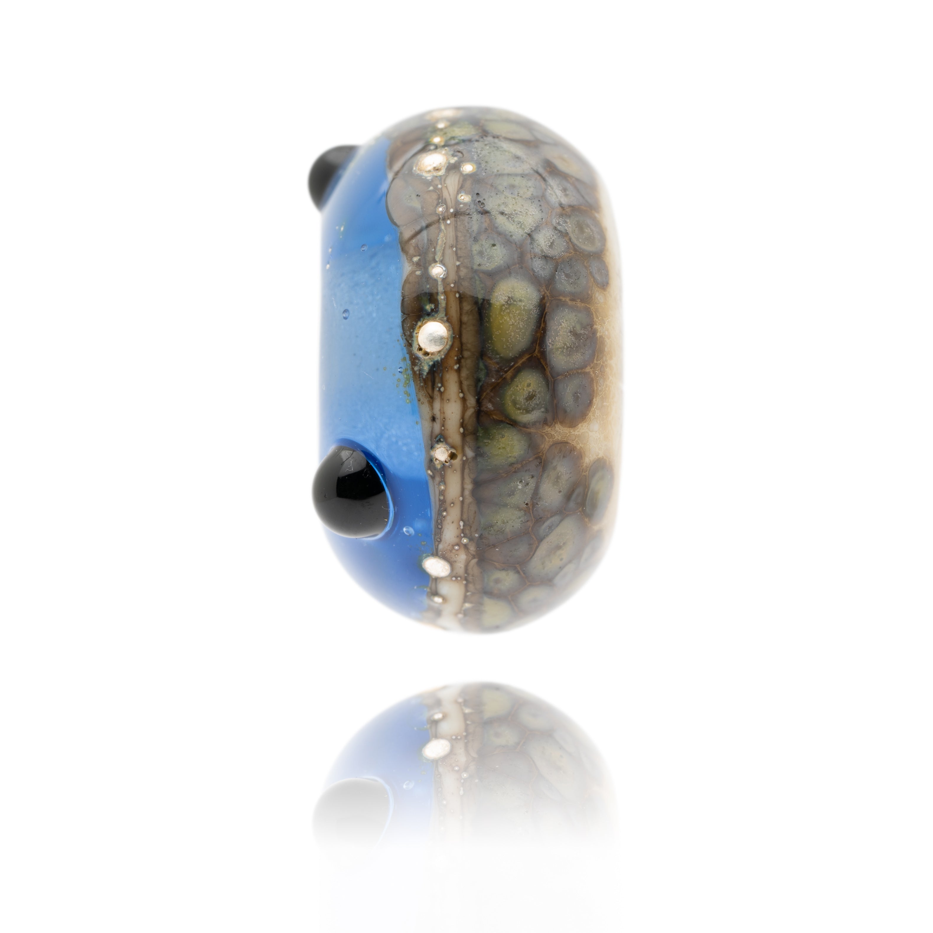 Blue and brown speckled glass bead with silver droplets and black dot patterns on the surface. Representing Southsea Beach in Hampshire, UK.