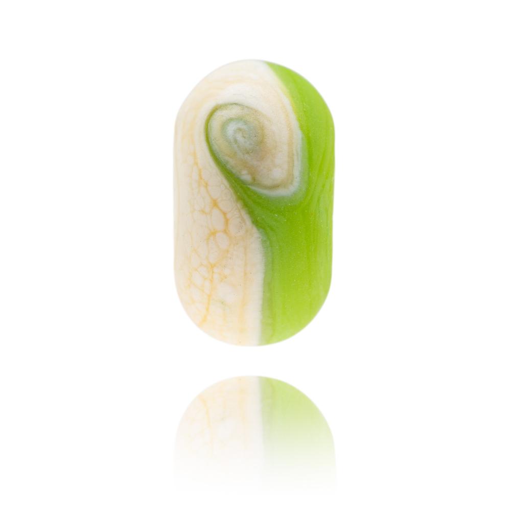 Green and ivory glass bead made to represent Southbourne Beach in Dorset.